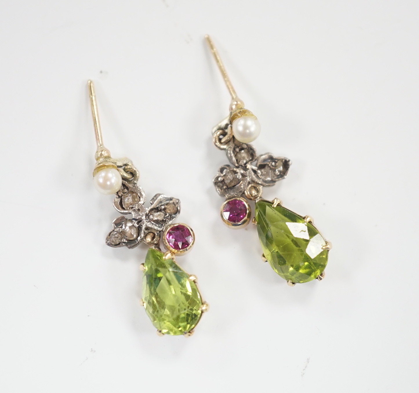 A pair of yellow metal, peridot, red stone, cultured pearl and rose diamond cluster set drop earrings, 25mm, gross weight 3.9 grams.